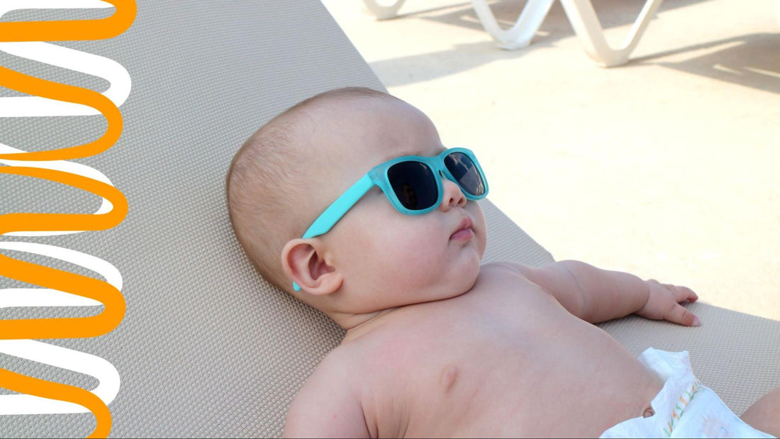 baby lying in the shade wearing blue sunglasses